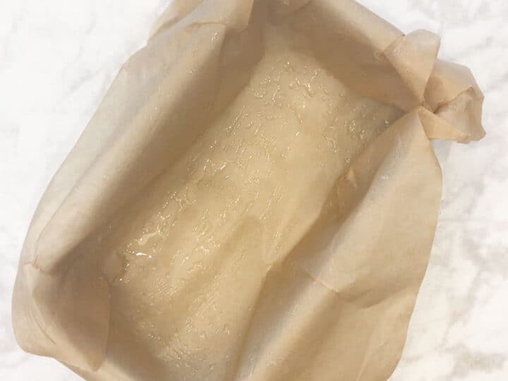 A parchment-lined small loaf pan.