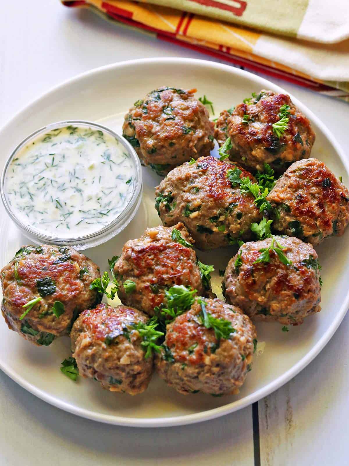 Lamb meatballs are served with a yogurt dip.