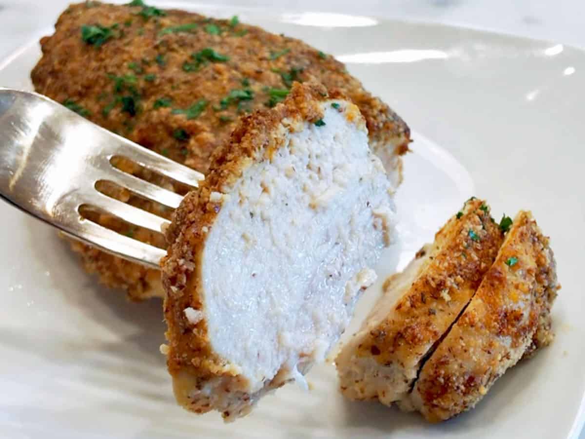 Slicing the chicken to show off its juiciness.