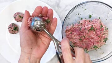 Measuring lamb meatballs.