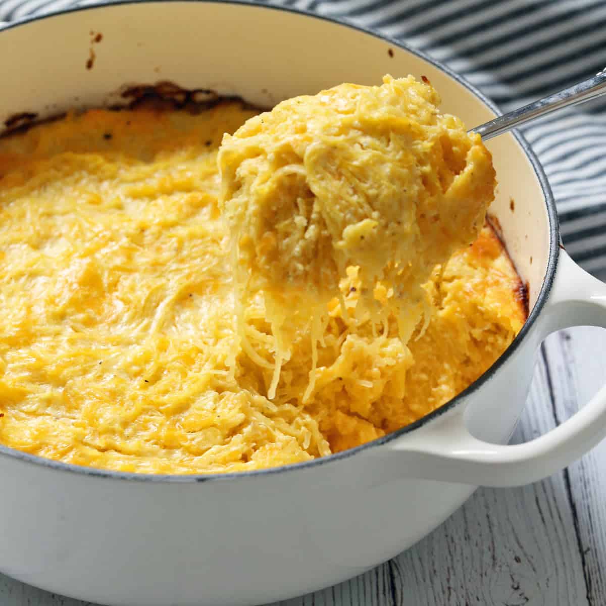 Spaghetti squash casserole is scooped out of the baking dish.