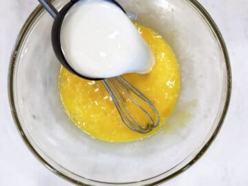 Adding milk to the batter.