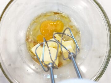 Mixing butter, stevia, vanilla, and eggs.