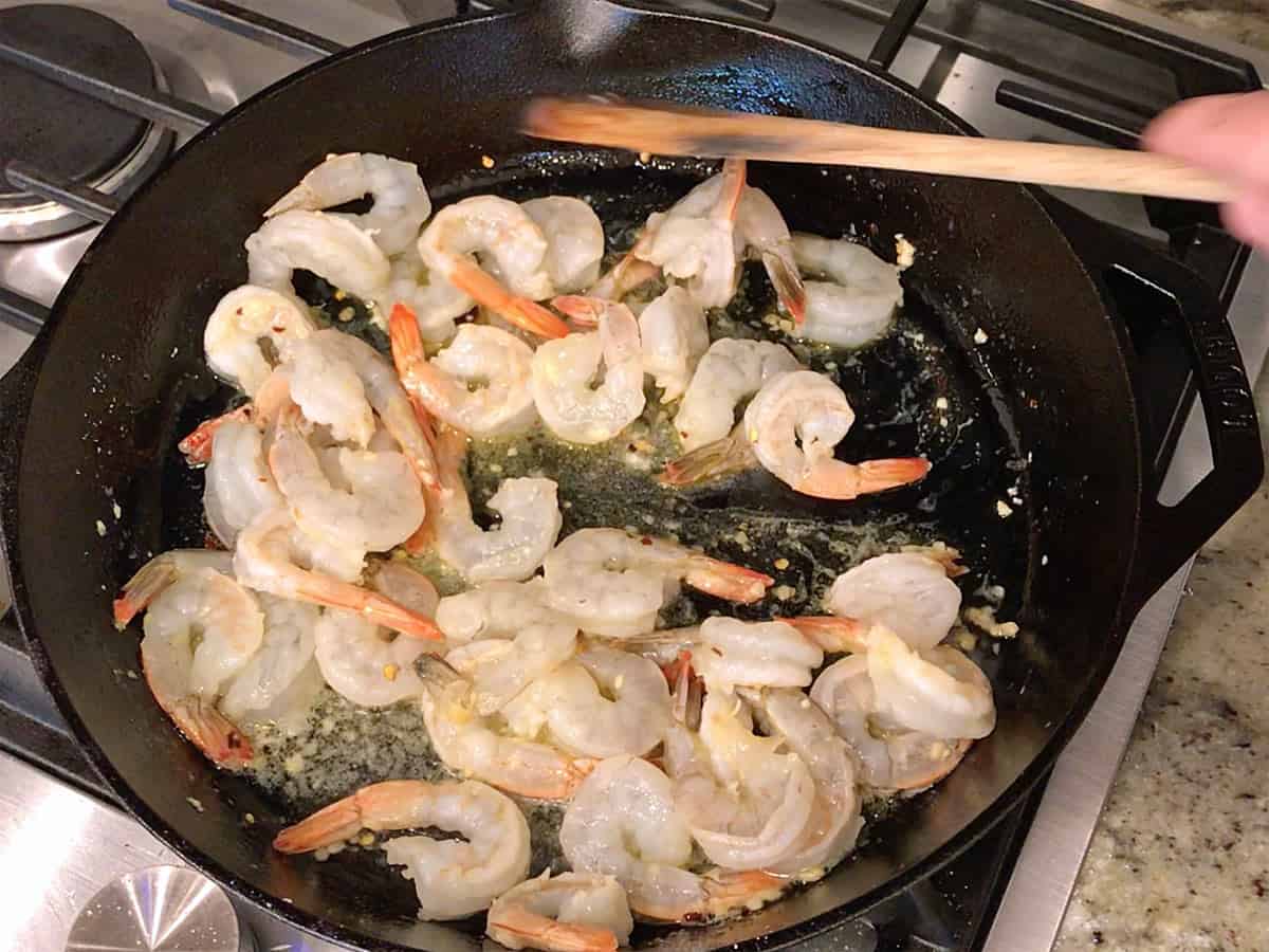 Cooking the shrimp in a skillet.