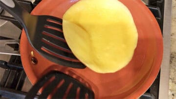 Flipping a crepe in the skillet.