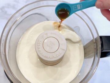 Adding the ingredients to the food processor's bowl.