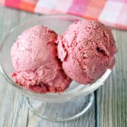 Two scoops of keto ice cream are served in a glass dessert cup.