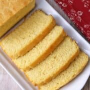 A sliced keto pound cake is served on a white tray.