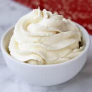 Sugar-free keto whipped cream is served in a white bowl.