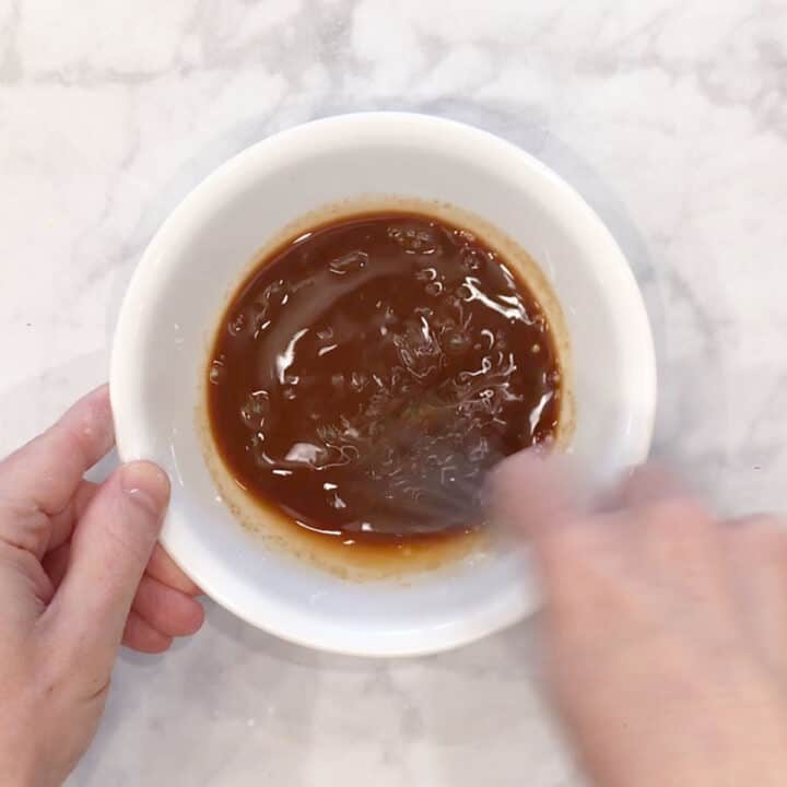 Mixing the sauce in a bowl.