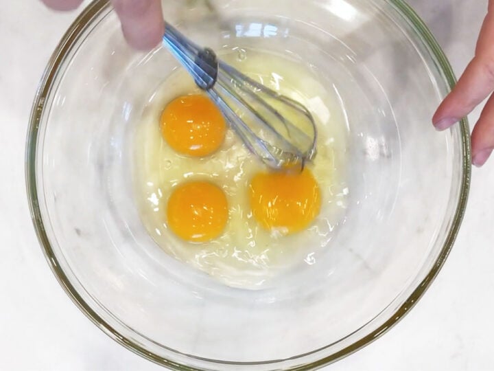 Whisking the eggs.