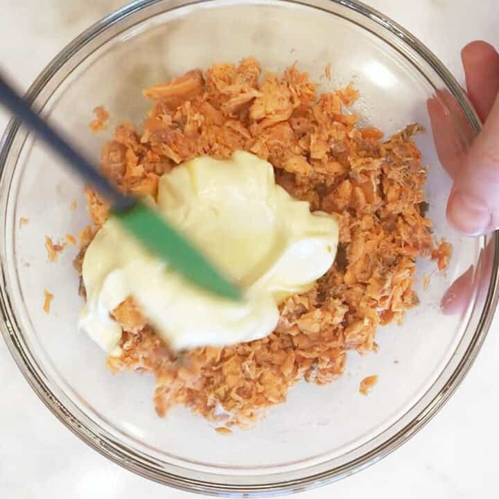 Adding mayonnaise.