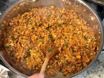 Adding spices, cilantro, and cheese.