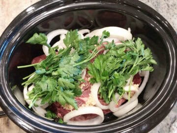 Veggies were added to the slow cooker pan.