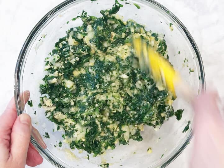 Mixing in flour and cheese.