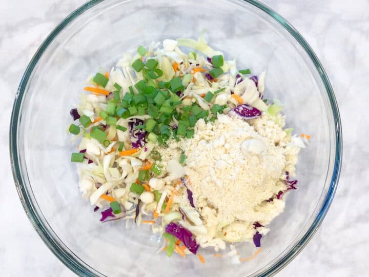 A bowl with cabbage, scallions, and almond flour.