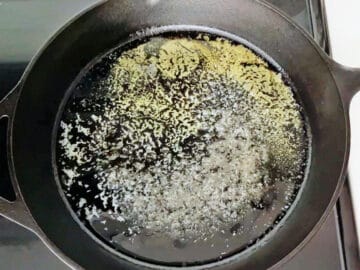 Heating butter in a cast iron skillet.