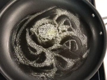 Butter foaming in a skillet.