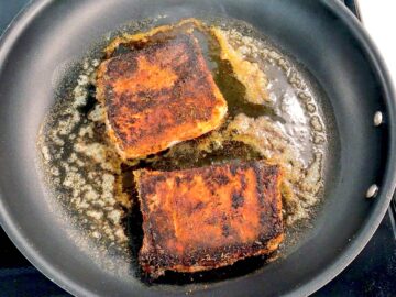 Cooking the fish on the second side.