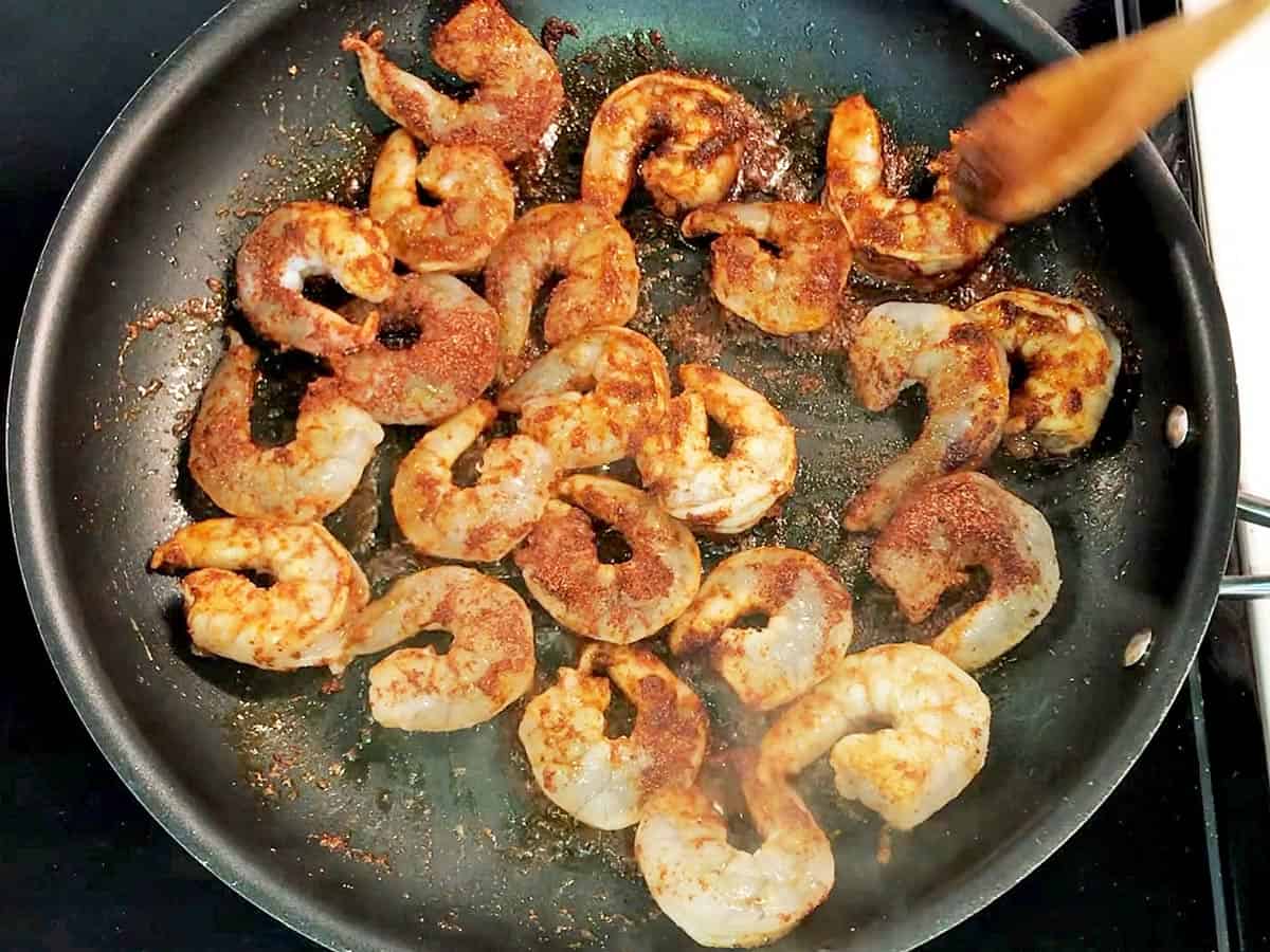 Cooking the shrimp in a skillet.