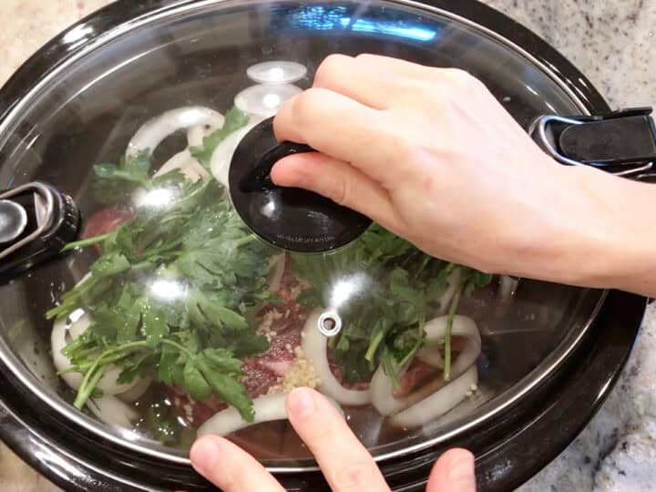 Covering the slow cooker pan.