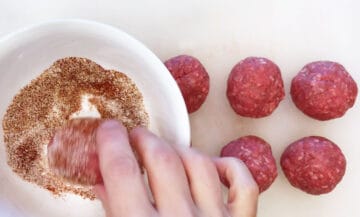 Dipping the meatballs in spices.