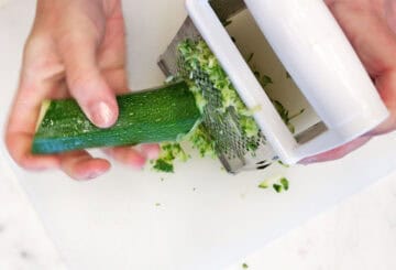 Grating zucchini.