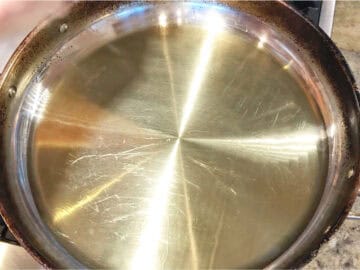 Heating the oil in the skillet.