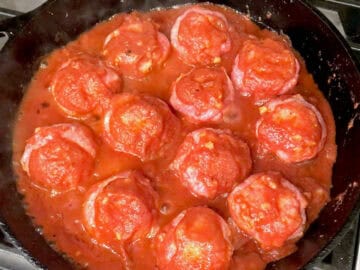 The meatballs were added to the sauce in the skillet.