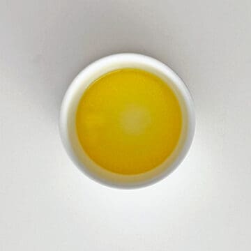 Melted butter in a ramekin.