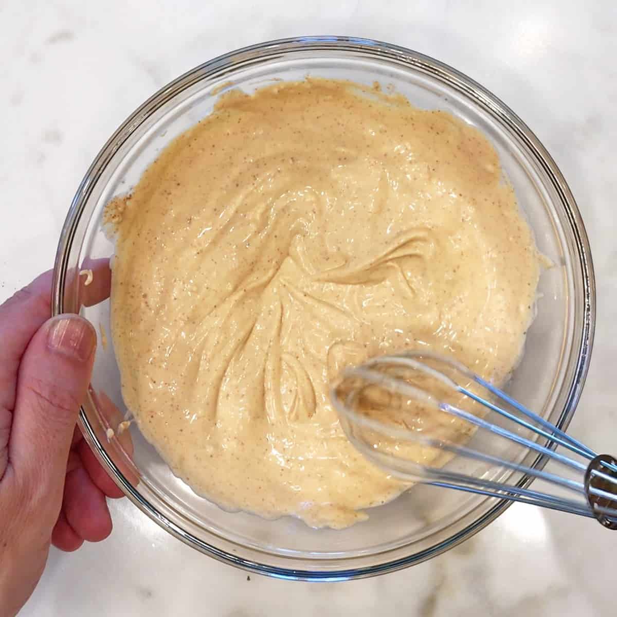 Mixing cream cheese, mayo, Dijon, and spices in a bowl.