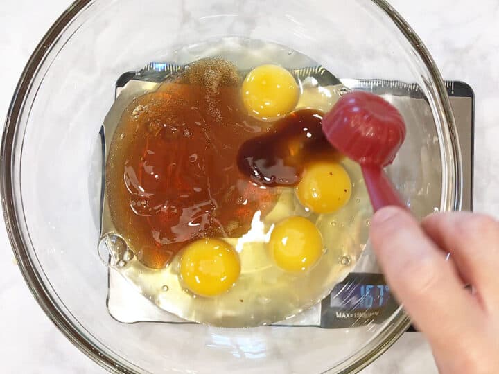 Adding the liquid ingredients to a bowl.
