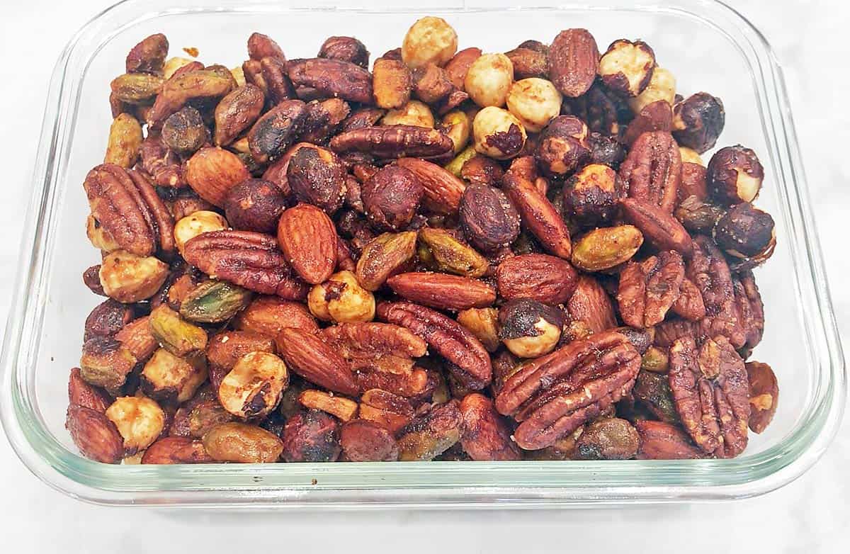 The nuts are stored in a glass container.
