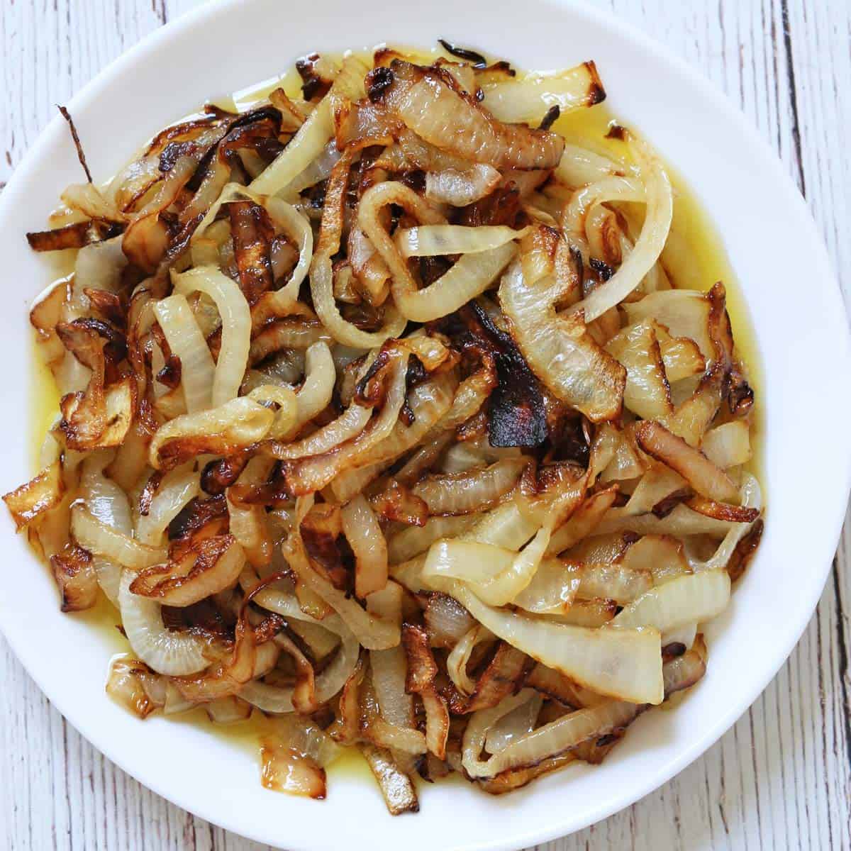 sauteed onions on a white plate.