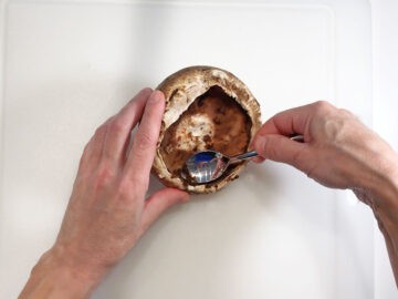 Scraping off the mushroom's gills.