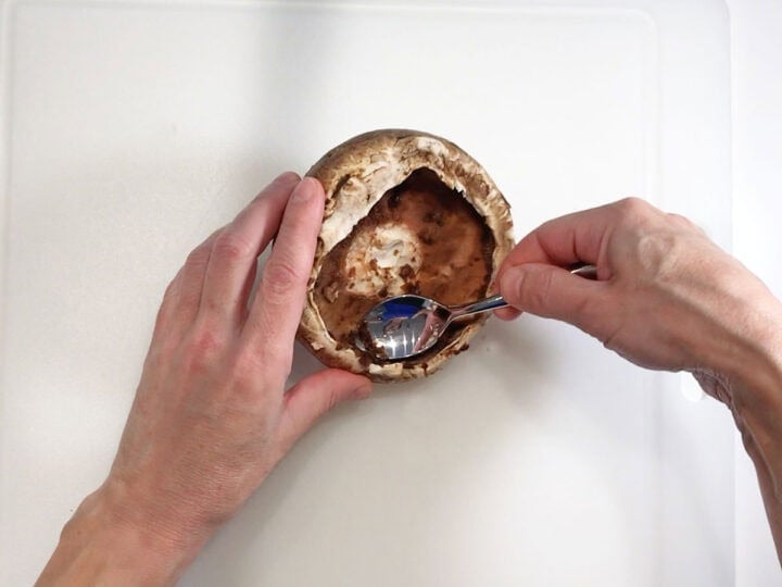 Scraping off the mushroom's gills.