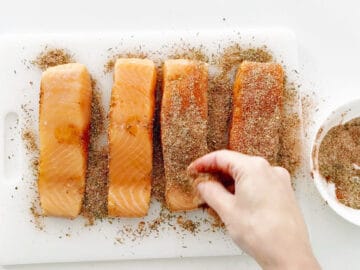 Seasoning the salmon.