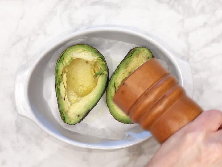 Seasoning the avocado.