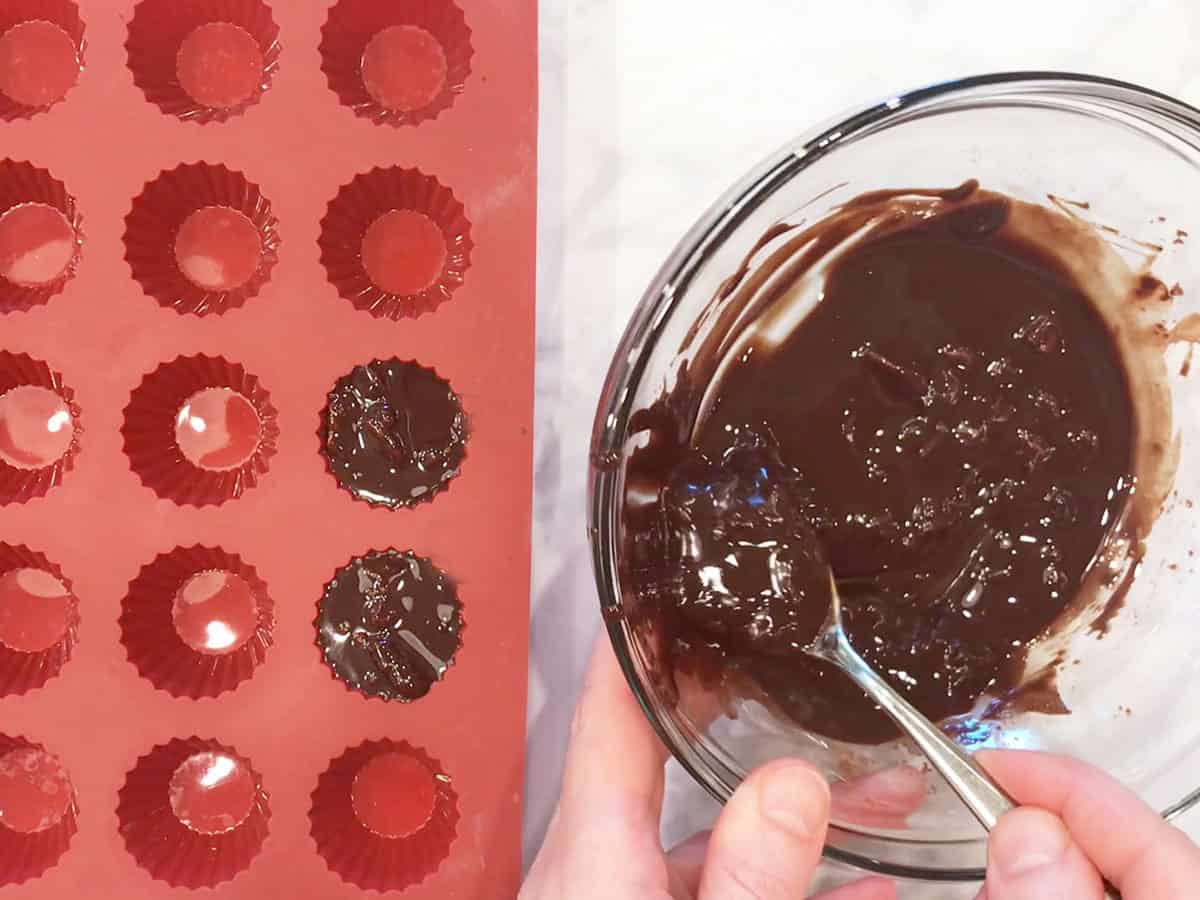 Spooning the chocolate mixture into the mold.