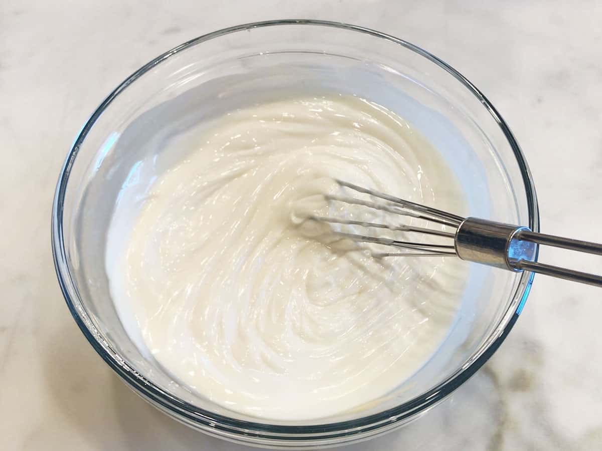 Whipping the frosting.