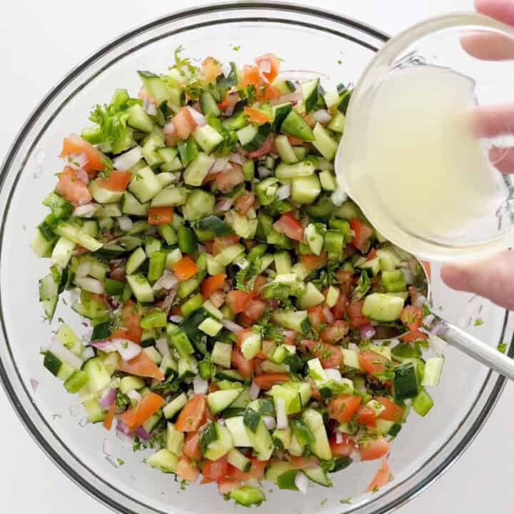 Adding lemon juice to the salad.