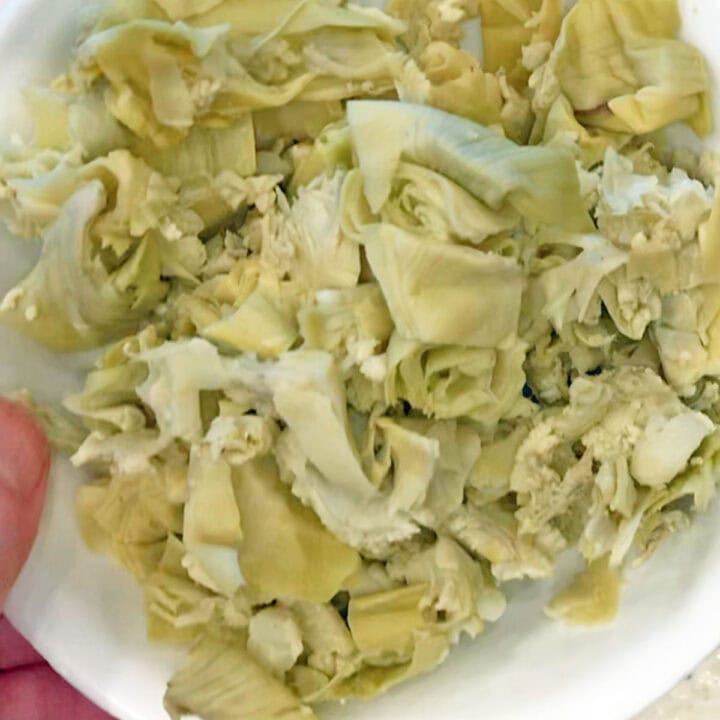 Chopped artichoke hearts on a plate.