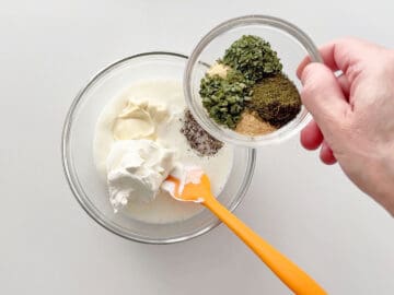 Combining the dressing ingredients in a bowl.