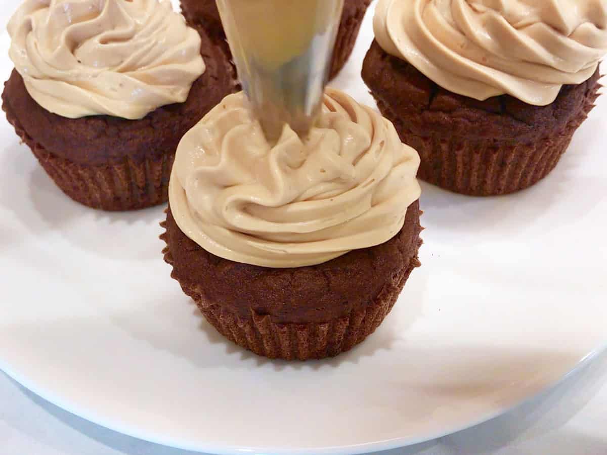 Frosting the cupcakes.