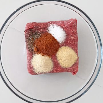 Ground beef and spices in a bowl.