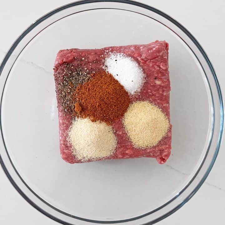 Ground beef and spices in a bowl.