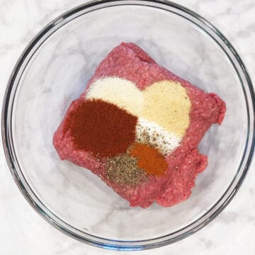 Ground beef and spices in a bowl.