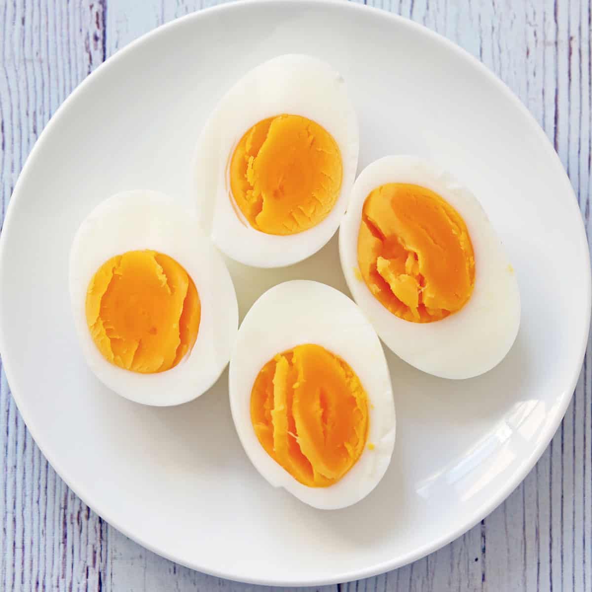Hard boiled eggs on a white plate.
