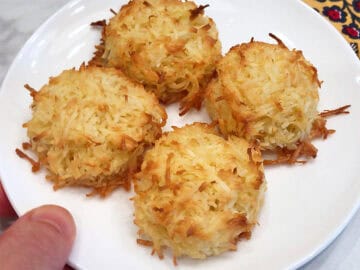 The macaroons are served on a white plate.