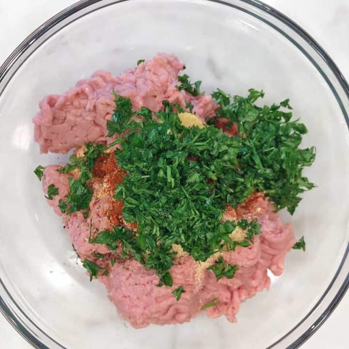 The meatball ingredients in a mixing bowl.